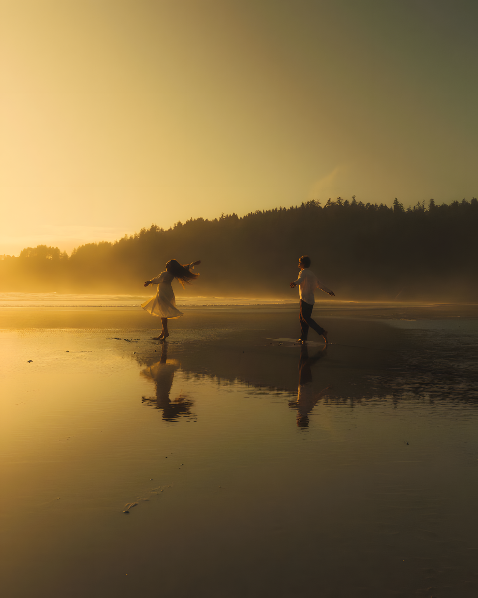 Two people enjoying a golden evening on the beach